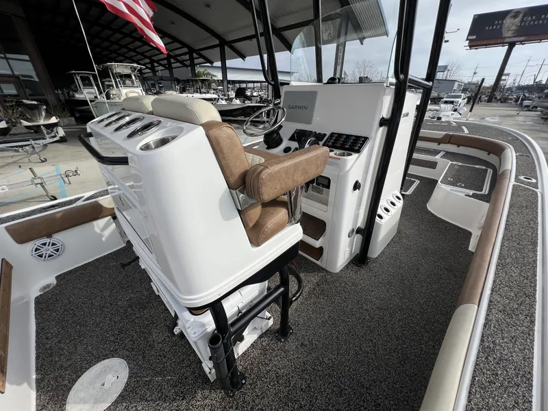 Slide: The Image of 2021 Caymas 26 HB boat interior with helm, seating, and navigation equipment. - 12