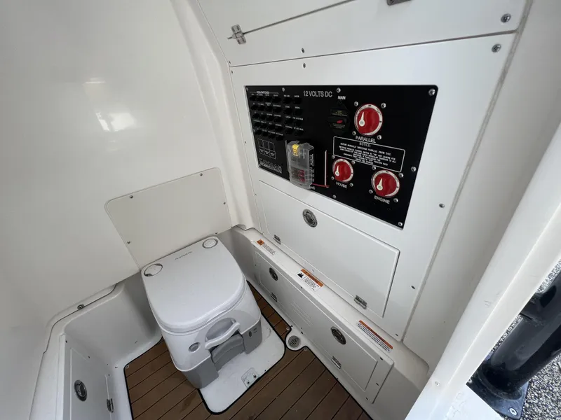 Slide: The Image of 2021 Caymas 26 HB boat interior with toilet and control panel. - 17
