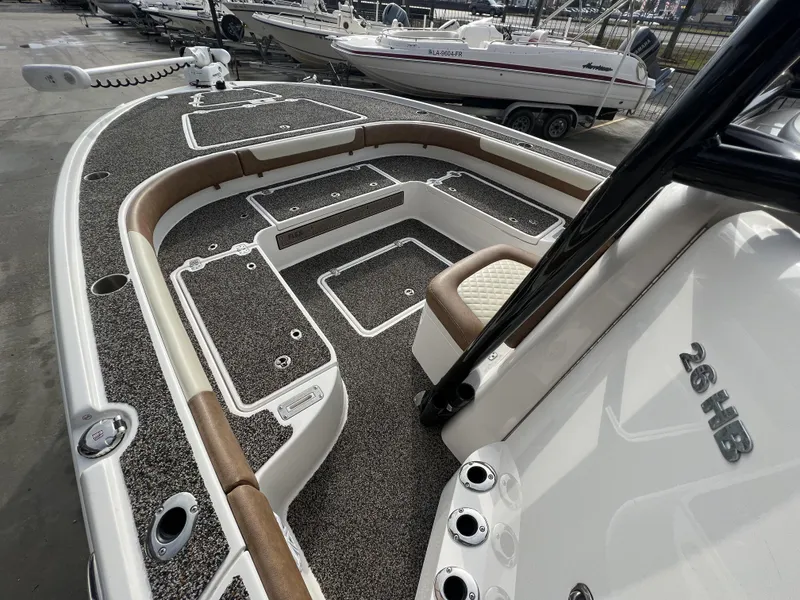 Slide: The Image of 2021 Caymas 26 HB boat interior with seating and storage compartments. - 21