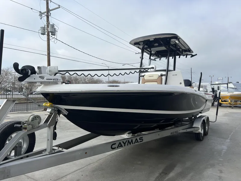 Slide: The Image of 2021 Caymas 26 HB boat on trailer, featuring Minn Kota trolling motor. - 3