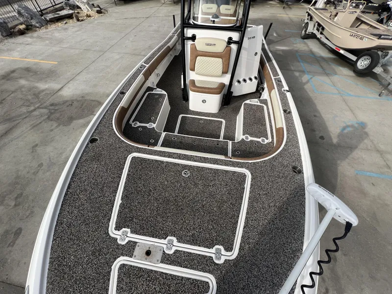 Slide: The Image of 2021 Caymas 26 HB boat interior with spacious deck and seating. - 6