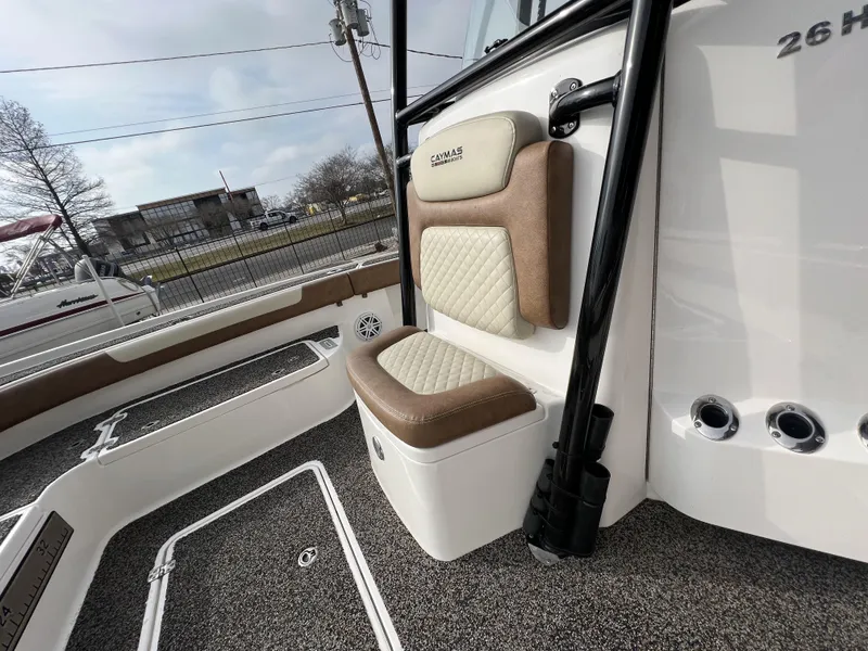 Slide: The Image of 2021 Caymas 26 HB boat interior with cushioned seating and textured flooring. - 7