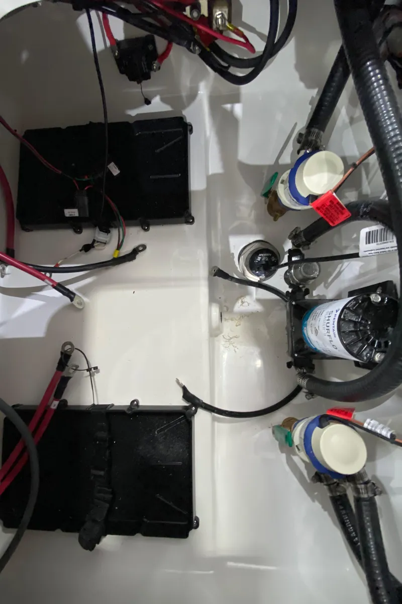 Slide: The Image of 2024 Sea Pro 202 boat wiring and components in the engine compartment. - 12