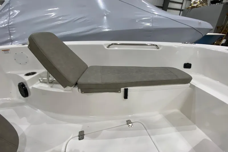 Slide: The Image of 2024 Sea Pro 202 boat interior with cushioned seating and storage compartment. - 6