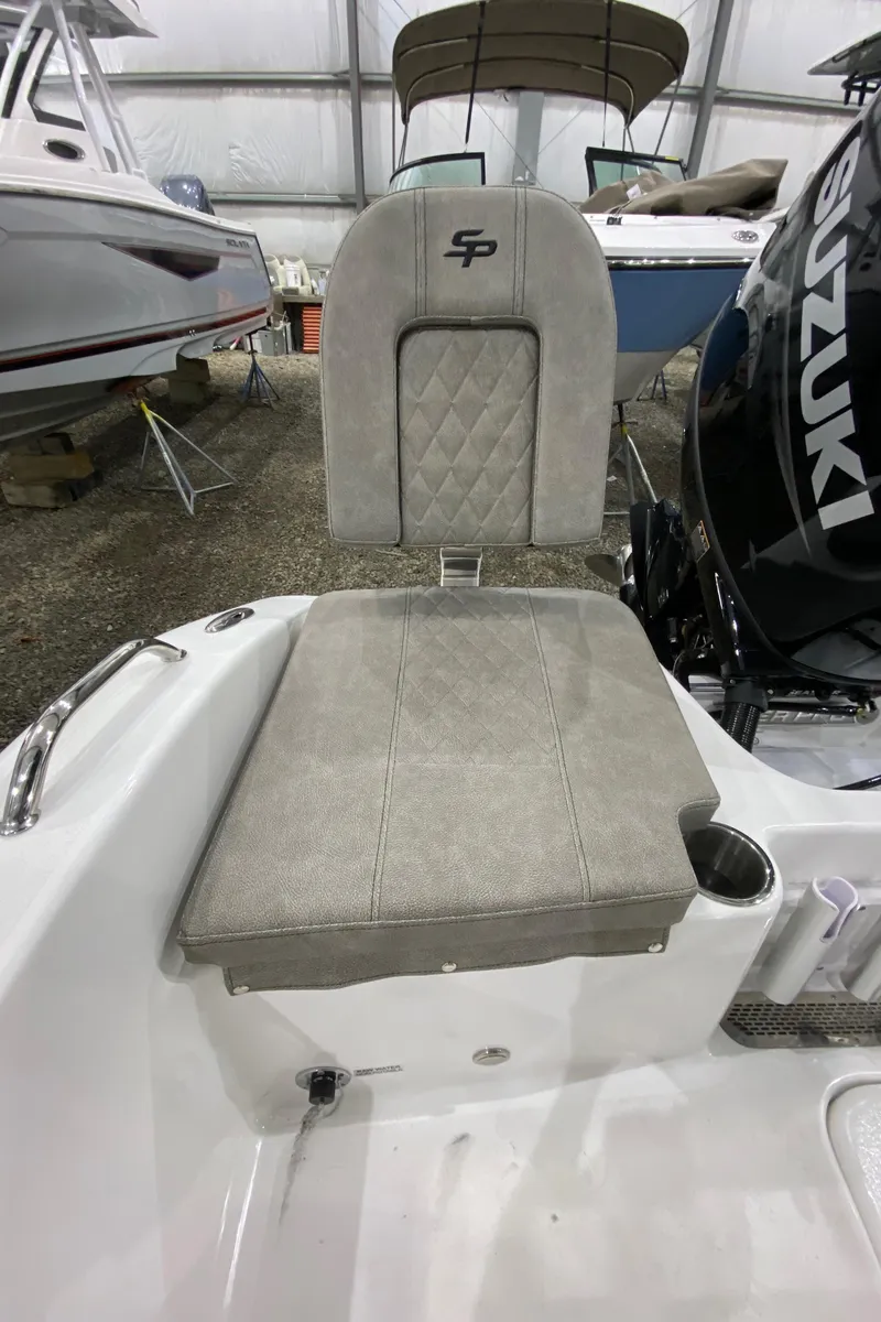 Slide: The Image of 2024 Sea Pro 202 boat seat with Suzuki engine in showroom. - 9