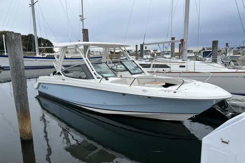 Slide: The Image of 2022 Boston Whaler 240 Vantage boat docked in a marina. - 0