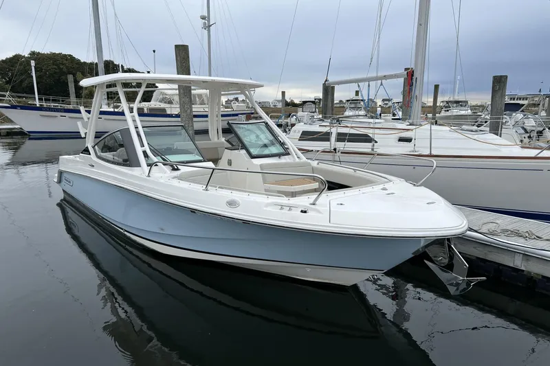 Slide: The Image of 2022 Boston Whaler 240 Vantage boat docked at a marina. - 1