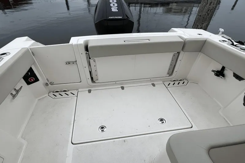Slide: The Image of 2022 Boston Whaler 240 Vantage boat deck with Mercury outboard motor. - 11