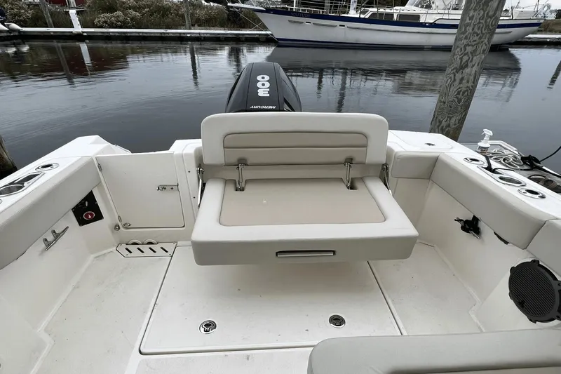 Slide: The Image of Boston Whaler 240 Vantage 2022 boat interior with foldable seating and Mercury 300 outboard motor. - 12