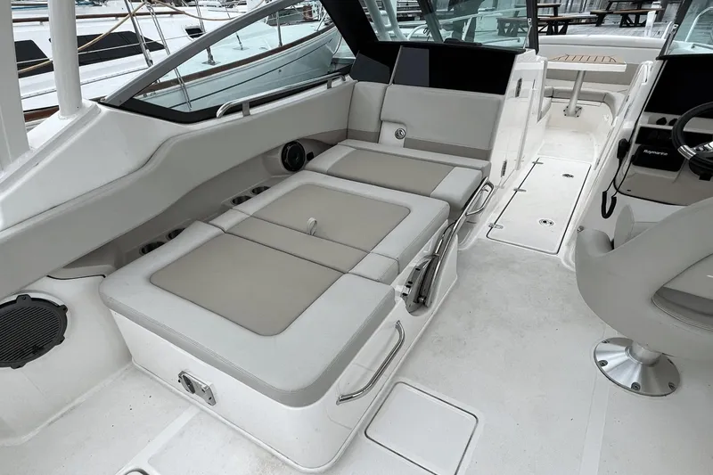 Slide: The Image of Interior of 2022 Boston Whaler 240 Vantage boat with cushioned seating and steering console. - 13
