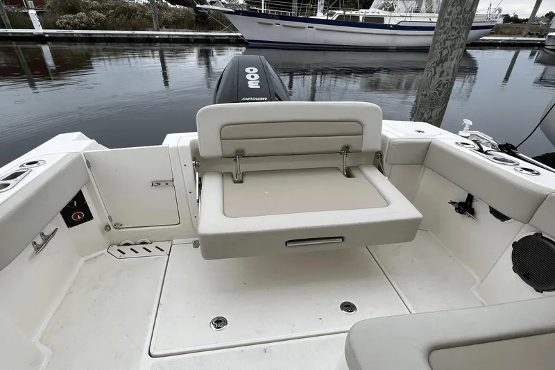 Slide: The Image of Boston Whaler 240 Vantage 2022 boat interior with foldable seating and Mercury 300 engine. - 14