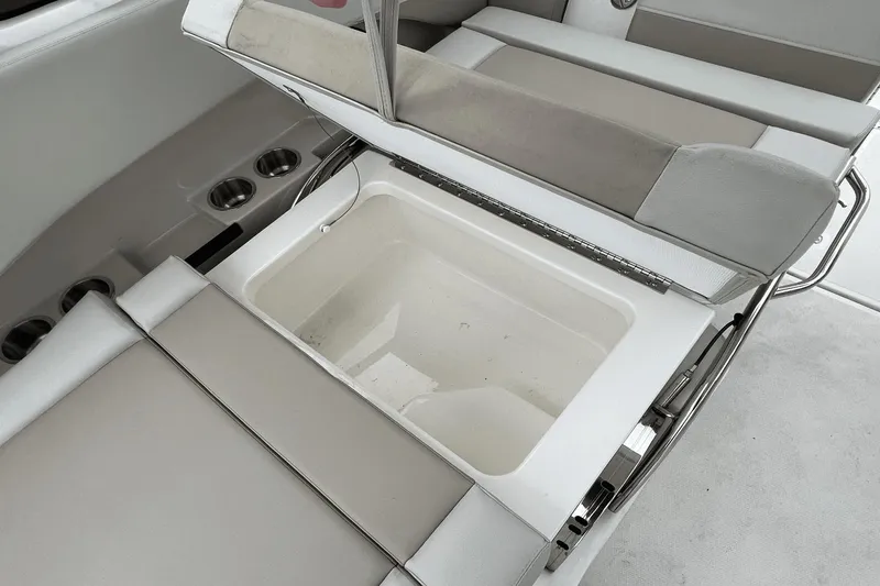 Slide: The Image of Boston Whaler 240 Vantage 2022 boat with open storage compartment and cup holders. - 16