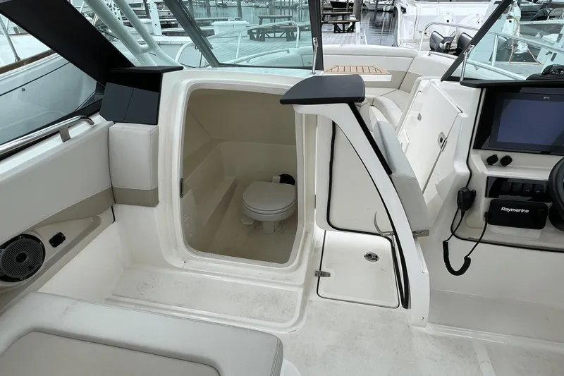 Slide: The Image of Interior of 2022 Boston Whaler 240 Vantage boat showing cabin with toilet. - 17