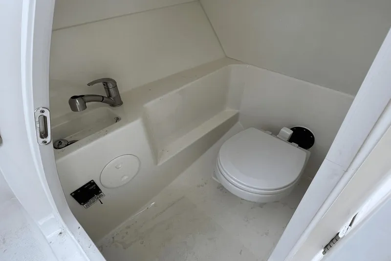 Slide: The Image of 2022 Boston Whaler 240 Vantage boat interior bathroom with toilet and sink. - 22