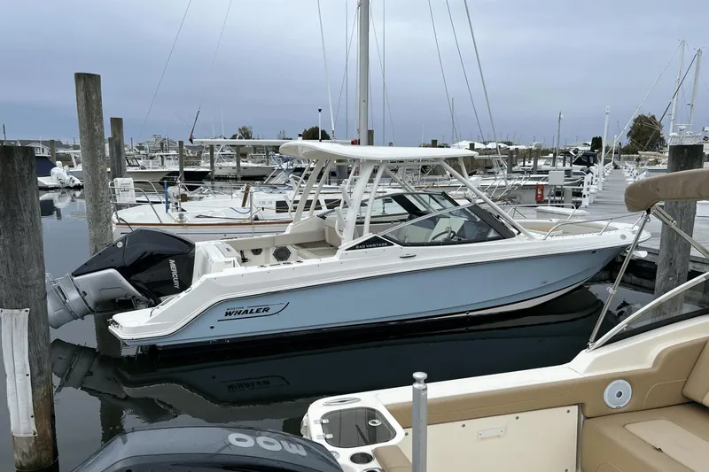 Slide: The Image of 2022 Boston Whaler 240 Vantage boat docked at a marina. - 27