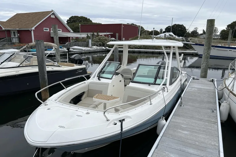Slide: The Image of 2022 Boston Whaler 240 Vantage docked at a marina. - 28