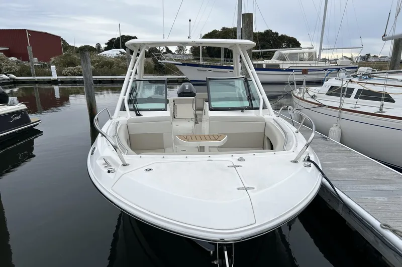 Slide: The Image of 2022 Boston Whaler 240 Vantage docked at a marina. - 3