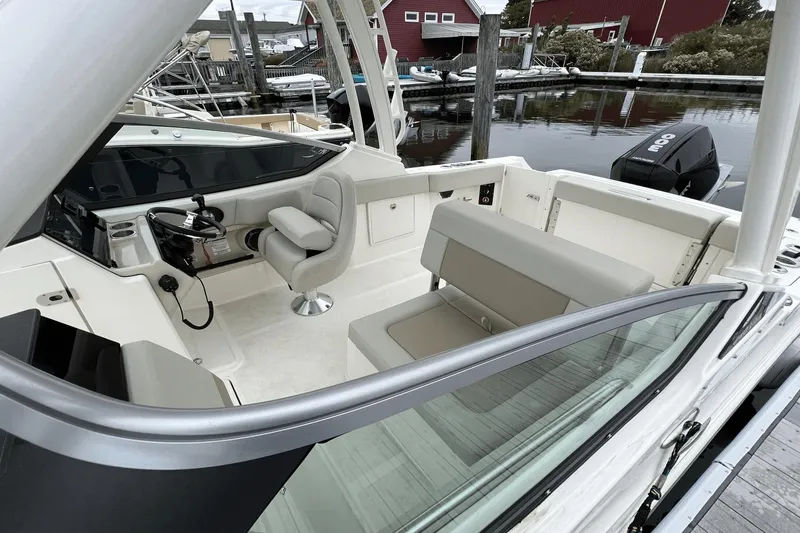 Slide: The Image of 2022 Boston Whaler 240 Vantage boat interior with helm and seating. - 6