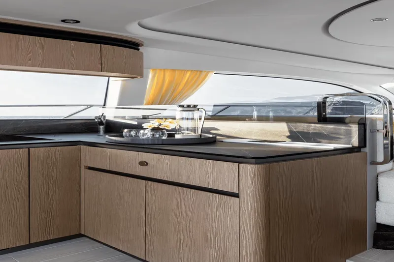 Slide: The Image of Luxurious kitchen interior of 2024 Azimut 53 Fly yacht with modern wood cabinetry. - 26