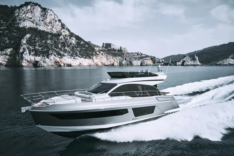 Slide: The Image of 2024 Azimut 53 Fly yacht cruising near rocky coastline. - 22