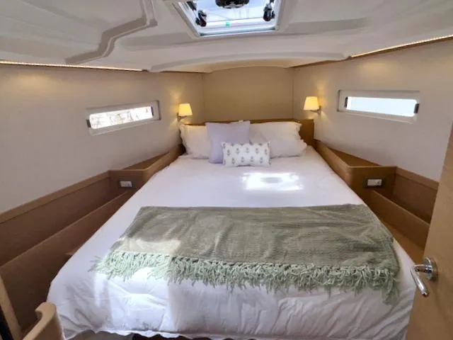 Slide: The Image of Luxurious cabin interior of 2024 Jeanneau Sun Odyssey 410 yacht with cozy bedding. - 20