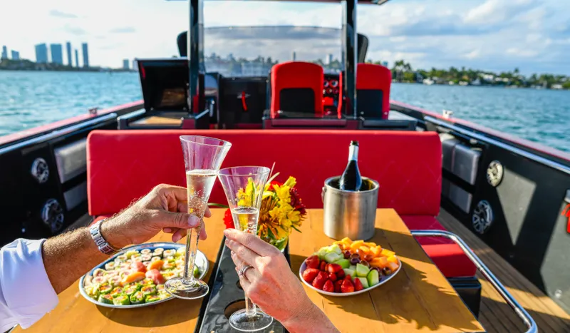 Slide: The Image of Couple toasting champagne on a 2008 Fjord Express yacht with fruit platter and city skyline. - 11