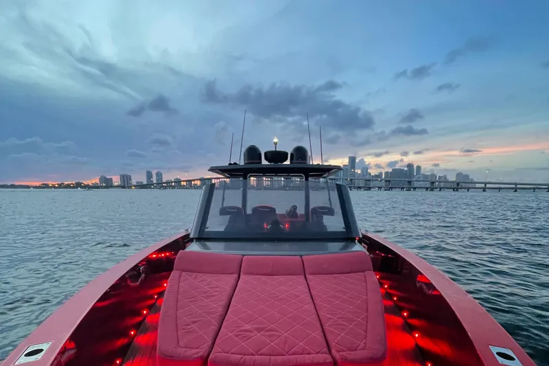 Slide: The Image of 2008 Fjord Express boat with red seating, city skyline at sunset in the background. - 13