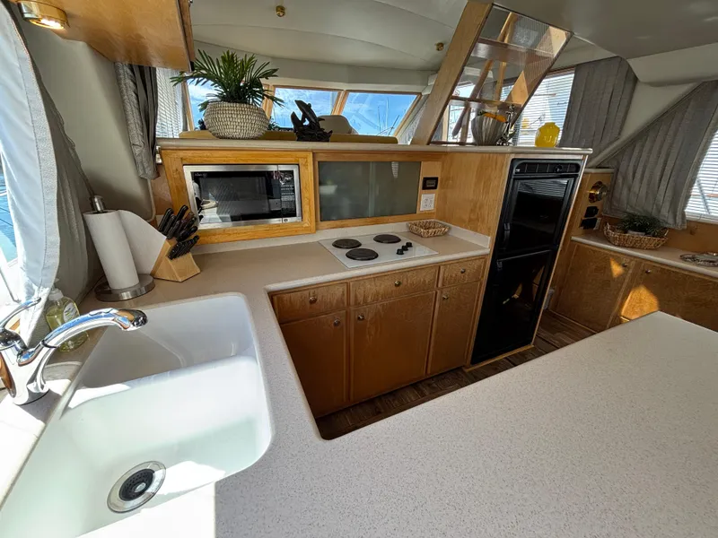 Slide: The Image of Luxurious kitchen interior of 2000 Navigator 5300 yacht with modern appliances and wooden cabinetry. - 11