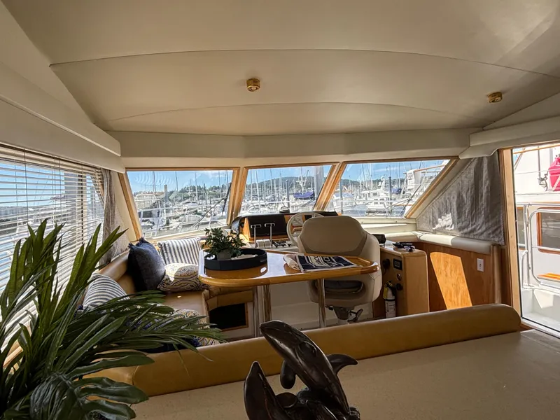 Slide: The Image of Interior of 2000 Navigator 5300 yacht with marina view through large windows. - 13