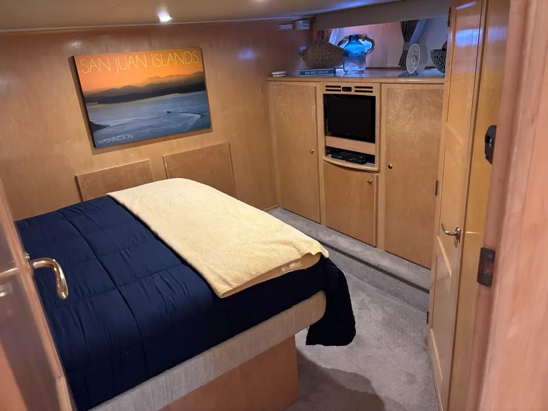 Slide: The Image of Cozy bedroom in 2000 Navigator 5300 yacht with TV, artwork, and plush bedding. - 18