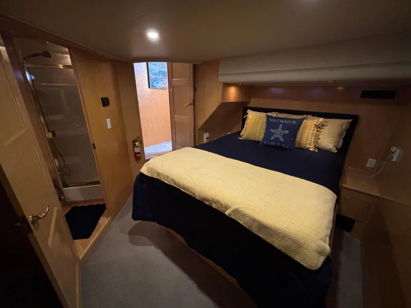 Slide: The Image of Cozy bedroom in 2000 Navigator 5300 yacht with plush bedding and wooden interior. - 19