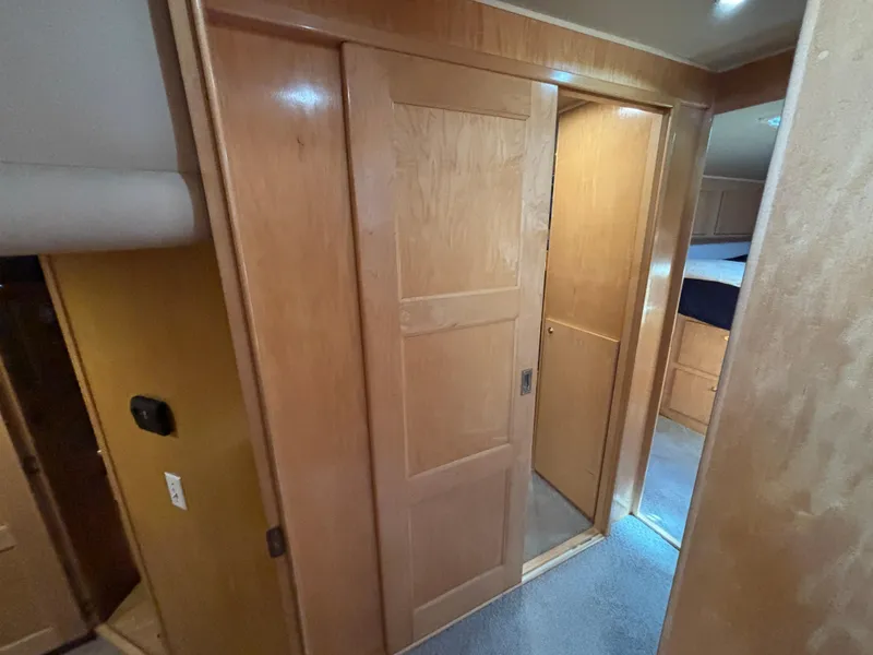 Slide: The Image of Interior of a 2000 Navigator 5300 RV with wooden sliding door and carpeted floor. - 22