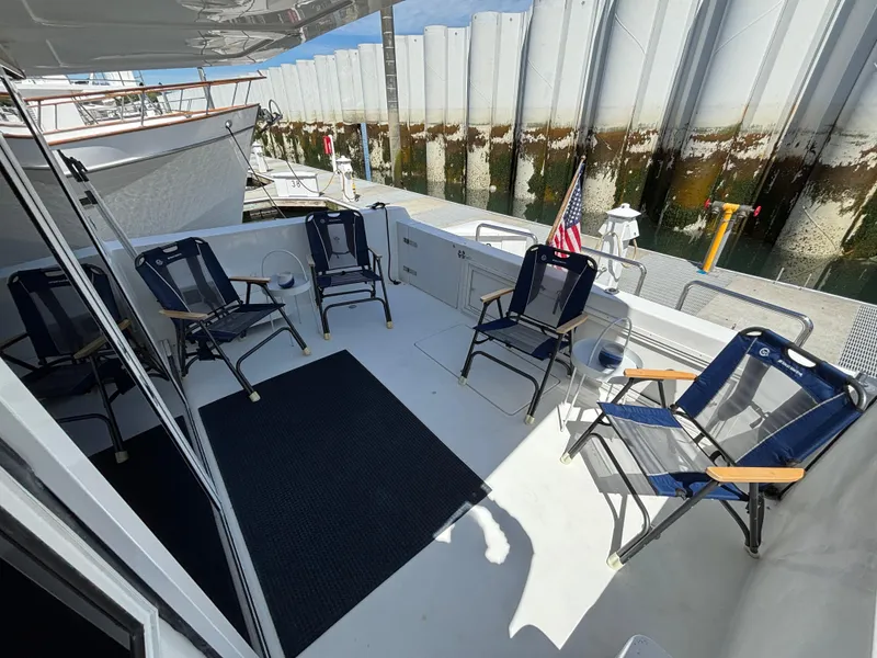 Slide: The Image of Deck of 2000 Navigator 5300 yacht with chairs and American flag. - 4