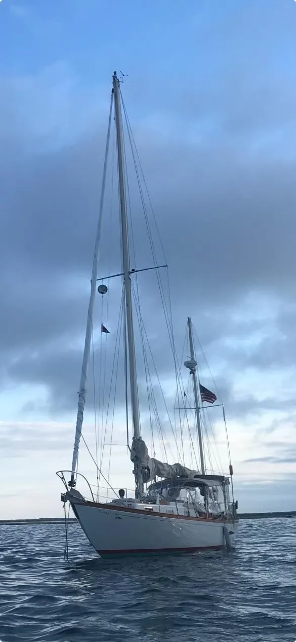 The Image of 1970 Cheoy Lee Offshore 40 sailboat on calm water under a cloudy sky. - 0