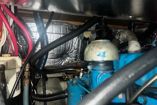 Slide: The Image of Engine compartment of a 1970 Cheoy Lee Offshore 40 sailboat, showing hoses and components. - 20