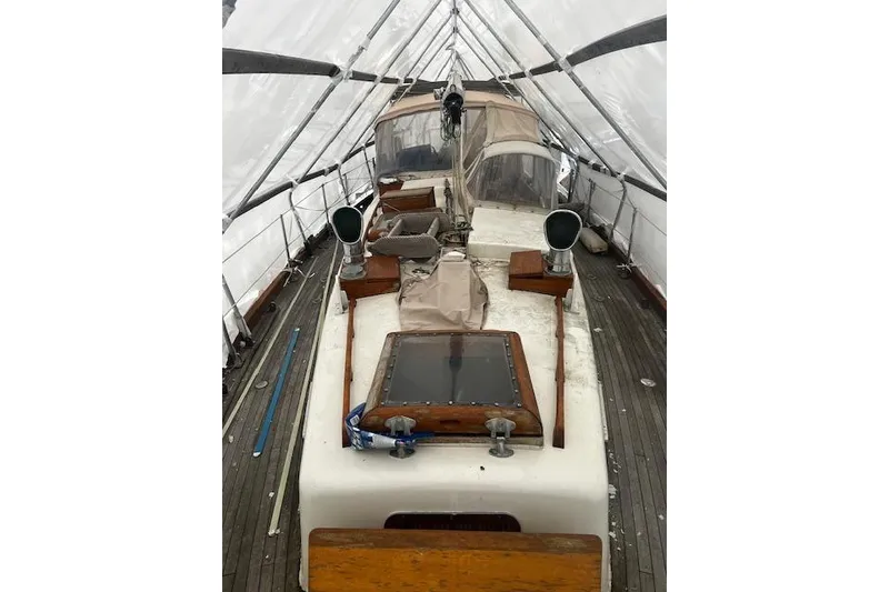 Slide: The Image of 1970 Cheoy Lee Offshore 40 sailboat mast under protective cover. - 3