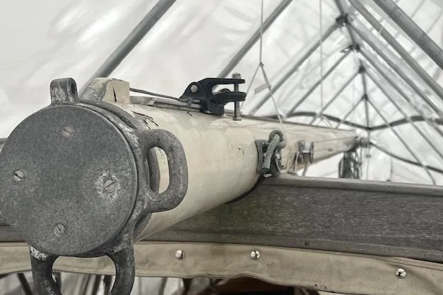 Slide: The Image of 1970 Cheoy Lee Offshore 40 sailboat interior with stacked cushions and wooden dashboard. - 4