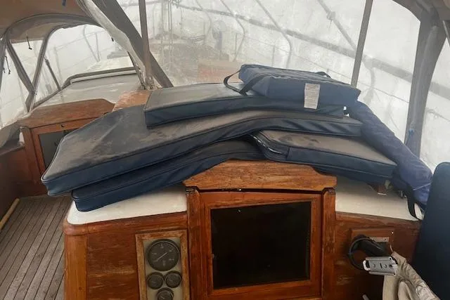 Slide: The Image of 1970 Cheoy Lee Offshore 40 sailboat deck with wooden planks and cabin windows. - 5