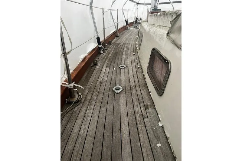 Slide: The Image of 1970 Cheoy Lee Offshore 40 yacht deck with anchor windlass and chain. - 6