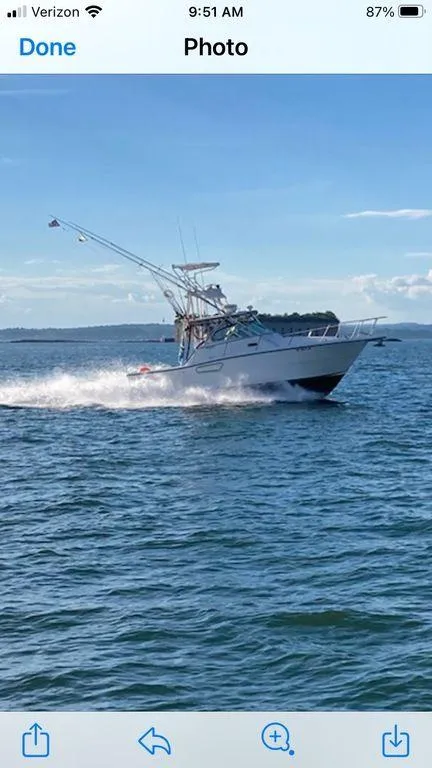 Slide: The Image of 2000 Rampage 30 Express boat cruising on open water. - 1