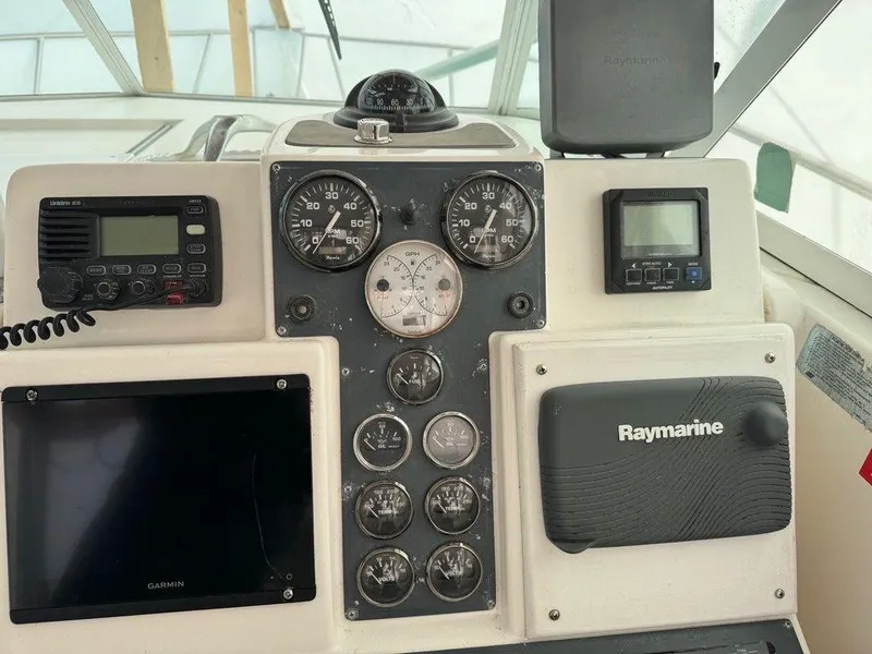 Slide: The Image of 2000 Rampage 30 Express boat dashboard with Raymarine and Garmin electronics. - 2