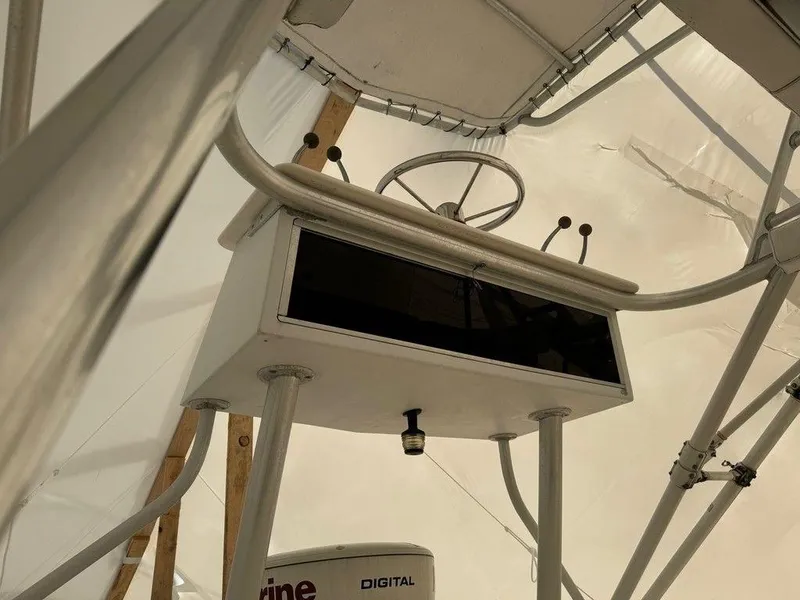 Slide: The Image of 2000 Rampage 30 Express boat helm station with steering wheel and controls. - 5