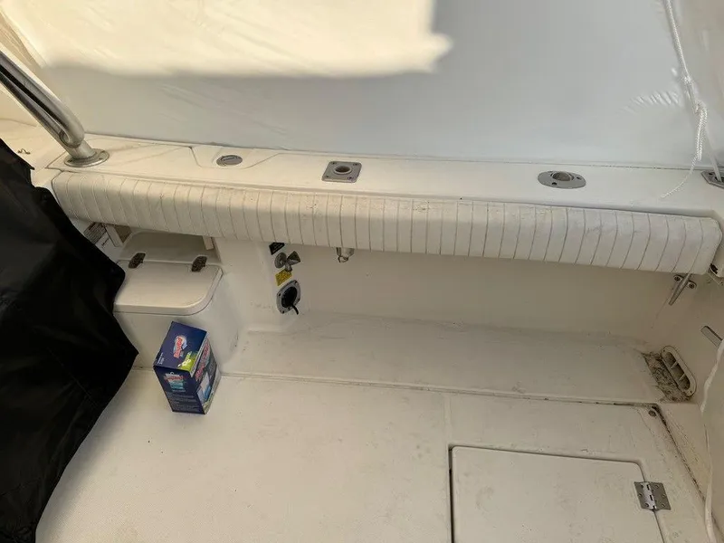 Slide: The Image of Interior of 2000 Rampage 30 Express boat with white seating and storage compartments. - 7