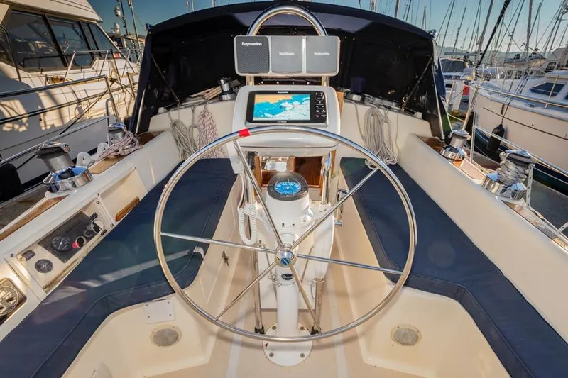 Slide: The Image of Steering wheel and navigation equipment on a 2002 Caliber 40 sailboat in a marina. - 12
