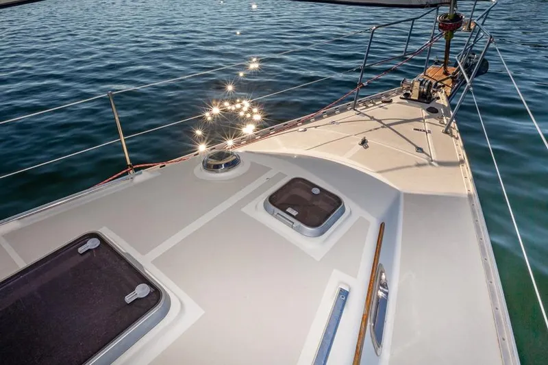 Slide: The Image of Deck of 2002 Caliber 40 sailboat with sparkling water reflections. - 16