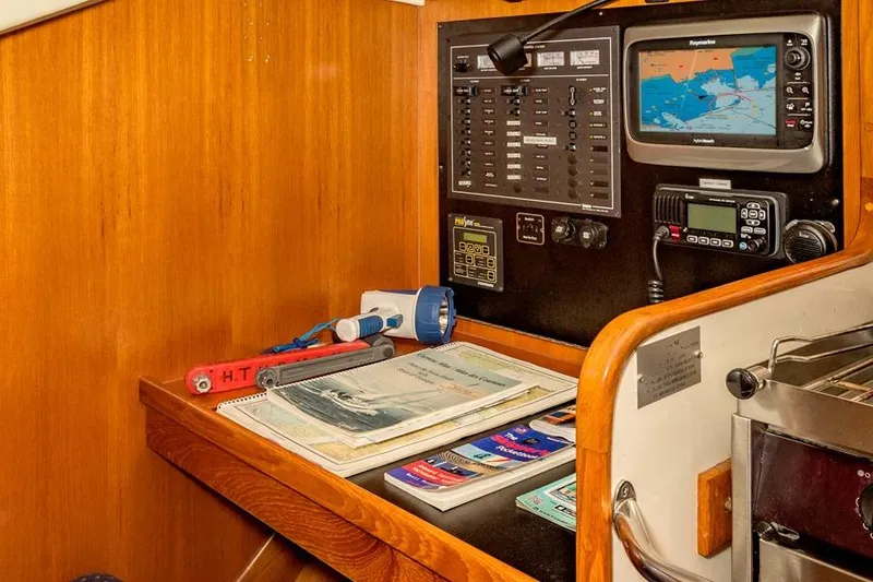 Slide: The Image of Navigation station on 2002 Caliber 40 yacht with maps, electronics, and flashlight. - 18