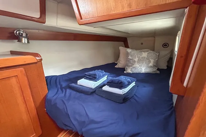 Slide: The Image of Cozy cabin interior of 2002 Caliber 40 sailboat with neatly arranged bedding. - 2
