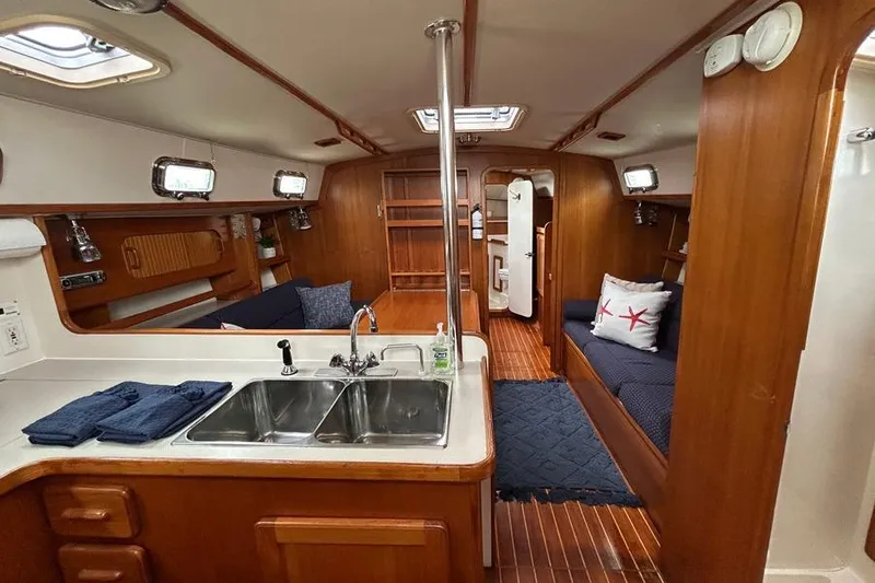 Slide: The Image of Interior of a 2002 Caliber 40 sailboat with wood finish and cozy seating. - 7