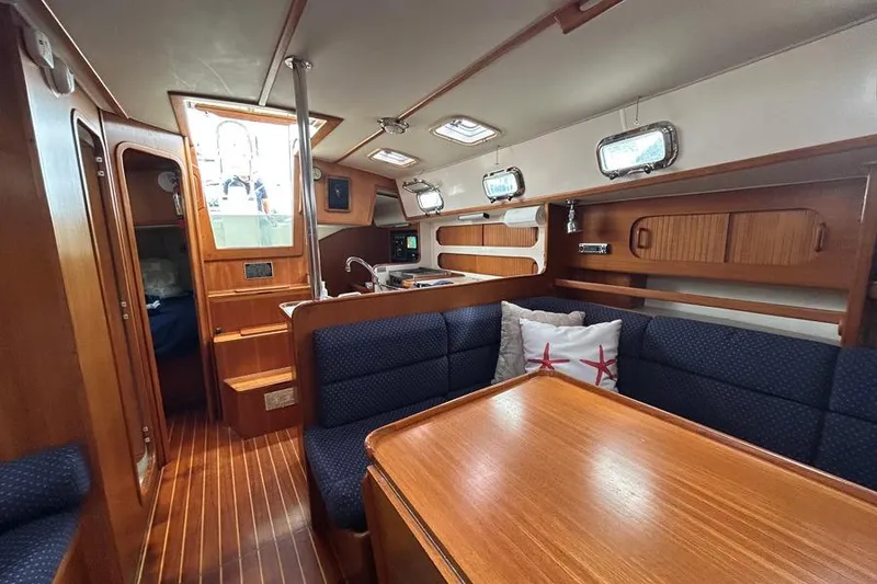 Slide: The Image of Interior of 2002 Caliber 40 sailboat with wood finish and cozy seating area. - 8
