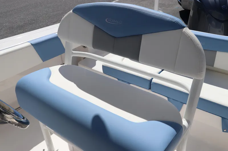Slide: The Image of 2024 Robalo R202 EX boat seating with blue and white upholstery. - 10